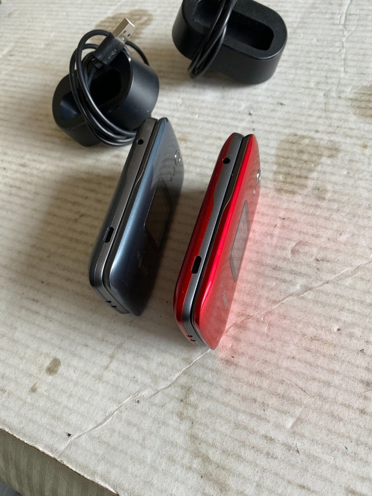 (2) pre-owned Lively Jitterbug flip phones red + gray w/ docking stations