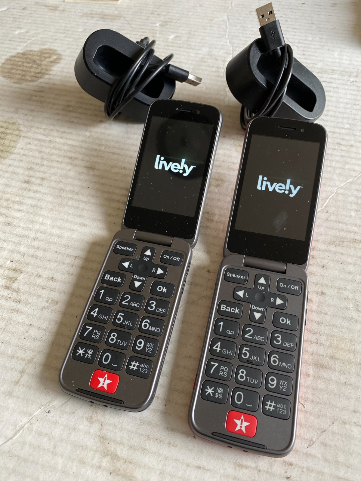 (2) pre-owned Lively Jitterbug flip phones red + gray w/ docking stations